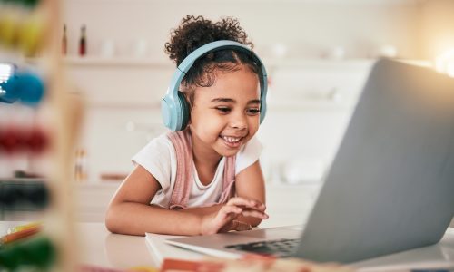 Laptop, home education and happy child elearning, kindergarten homework or remote school work. Knowledge website, learning software and young kid streaming youth development lesson on headphones.